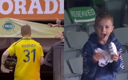 David Warner, the Australia opener, gives young people his batting gloves at the MCG after breaking his century-death drought.